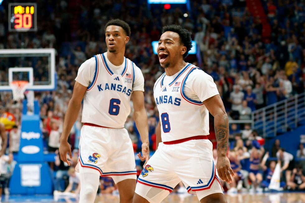 Kansas guard David Coit (8) reacts after scoring a 3-point basket alongside Rylan Griffen (6)...