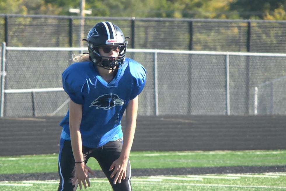 Among the sea of blue and black at Olathe Northwest football practice, you'll find Megan May.