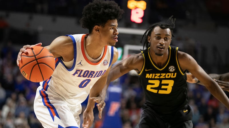 Florida guard Zyon Pullin (0) drives against Missouri forward Aidan Shaw (23) during the...