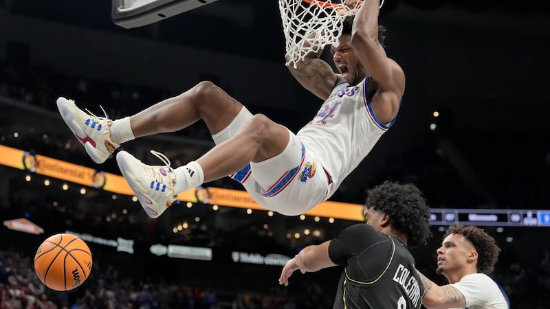 Kansas' KJ Adams Jr. (24) dunks over UCF's Dallan Coleman during the second half of an NCAA...