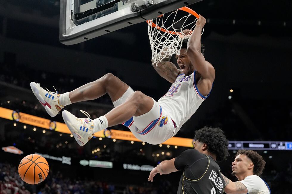 Kansas' KJ Adams Jr. (24) dunks over UCF's Dallan Coleman during the second half of an NCAA...