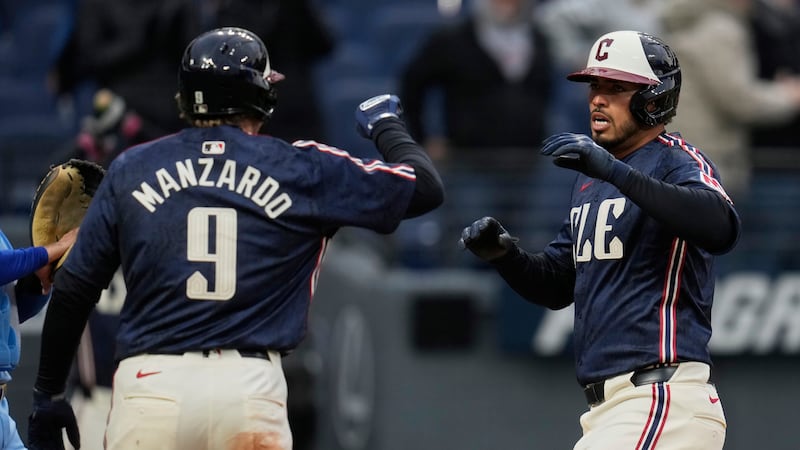 Cleveland Guardians' Gabriel Arias, right, celebrates with teammate Kyle Manzardo (9) after...