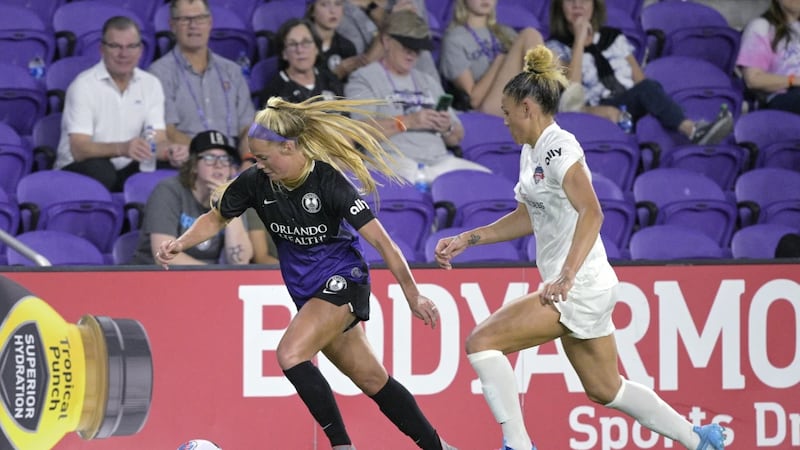 File - Orlando Pride midfielder Mikayla Cluff, left, controls the ball in front of Washington...