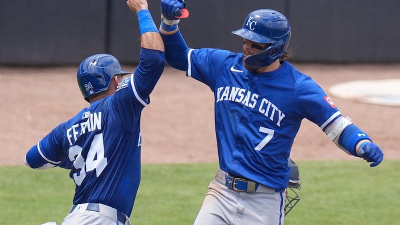 Kansas City Royals' Bobby Witt Jr. (7) celebrates with Freddy Fermin (34) after Witt Jr., hit...