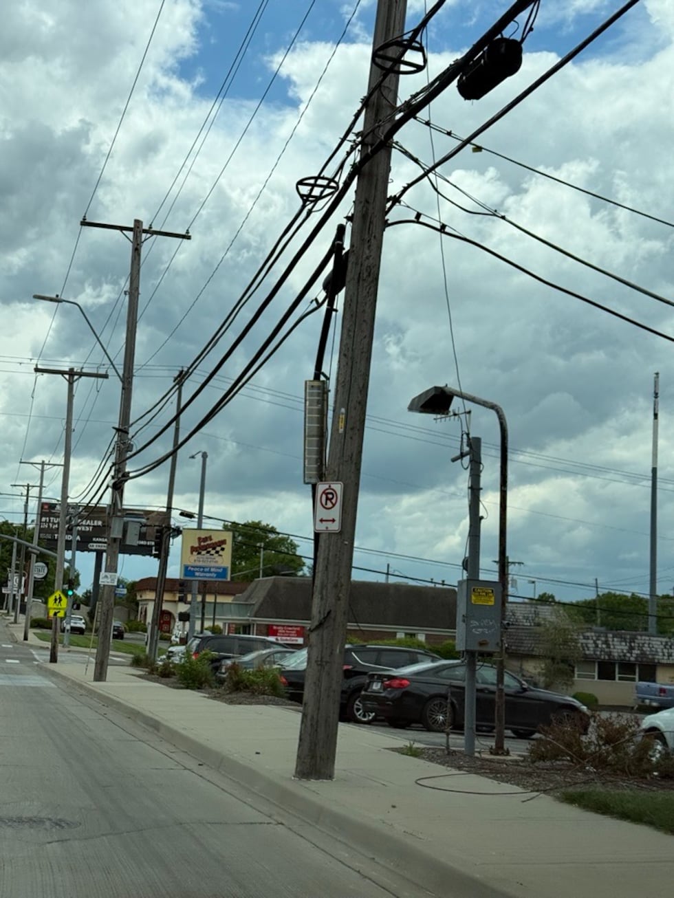 Picture shows a wooden power pole supporting a number of power lines. The power poles are...