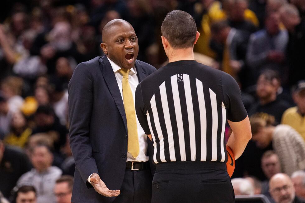 Missouri head coach Dennis Gates, left, argues a call with the referee, right, during the...