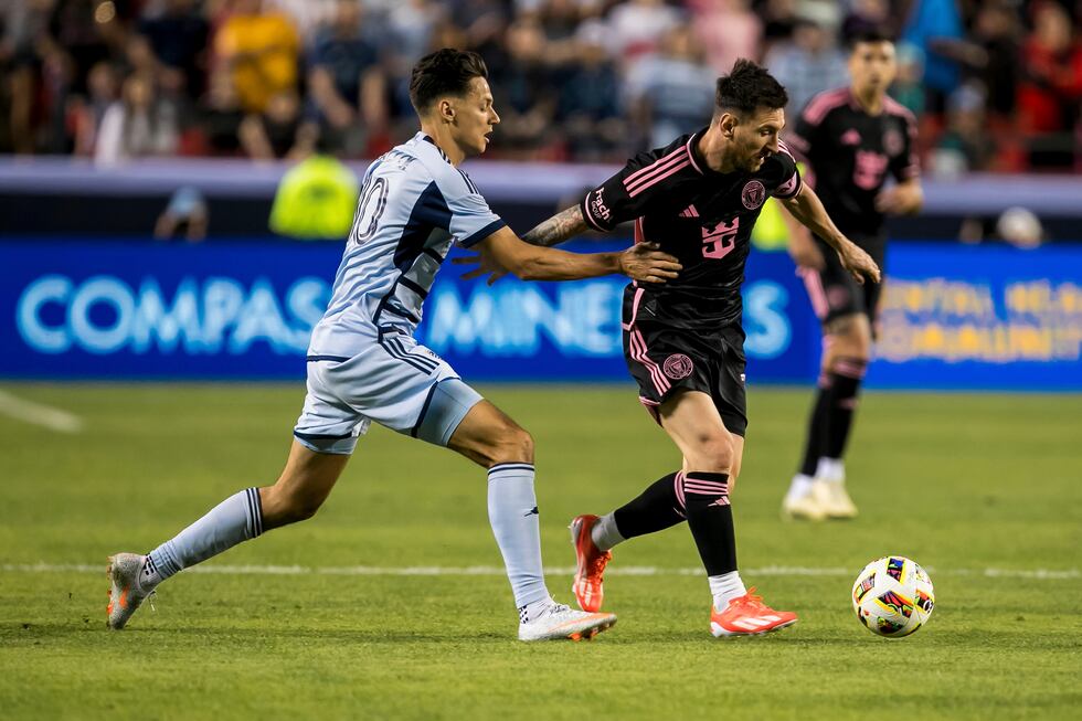 Inter Miami forward Lionel Messi, front right, shields off Sporting Kansas City forward Dániel...