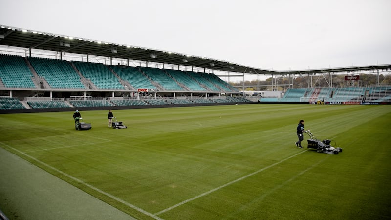 The CPKC Stadium grounds crew prepares the pitch for a playoff game.