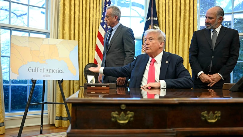 FILE - President Donald Trump gestures to a poster that says "Gulf of America" as Health and...