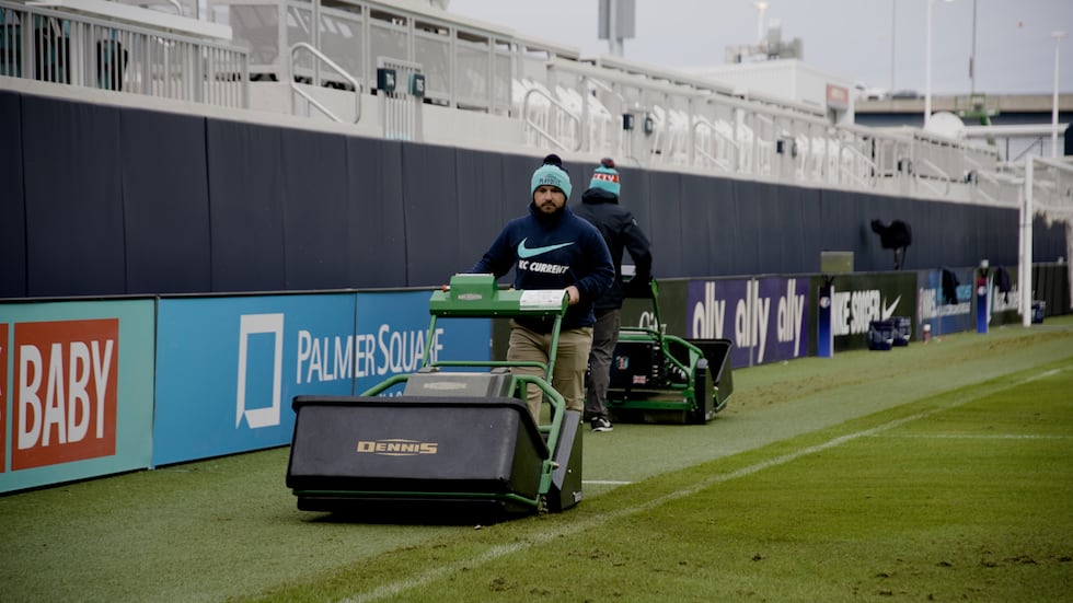 The CPKC Stadium grounds crew prepares the pitch for a playoff game.