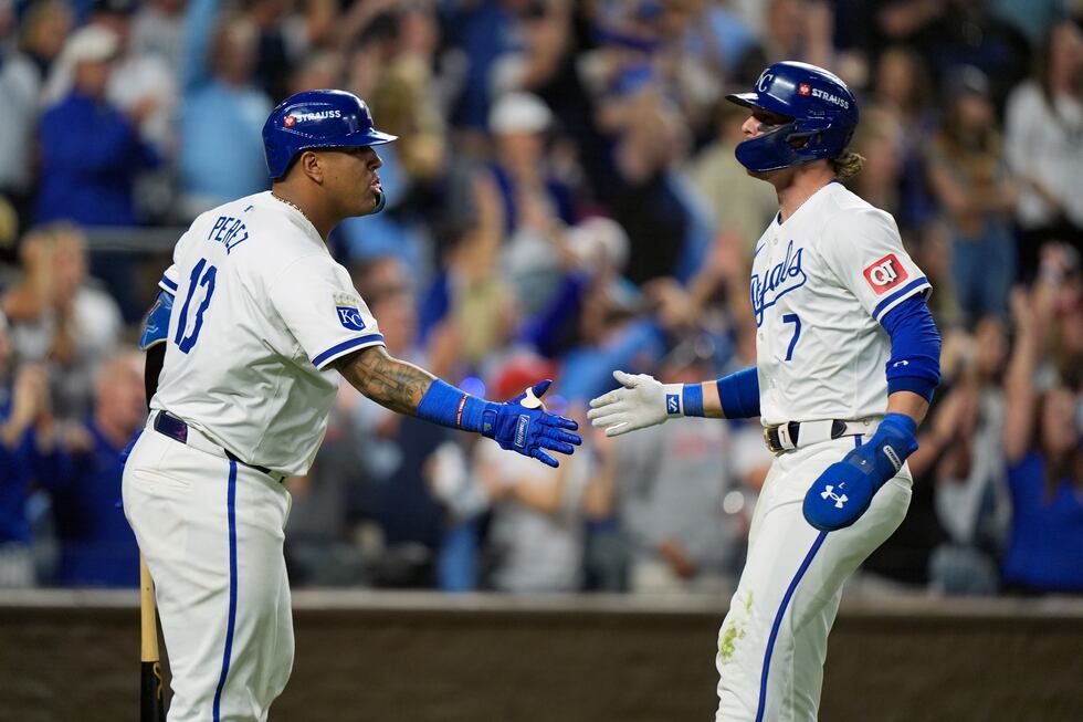 Kansas City Royals' Bobby Witt Jr. (7) is congratulated by teammate Salvador Perez (13) after...
