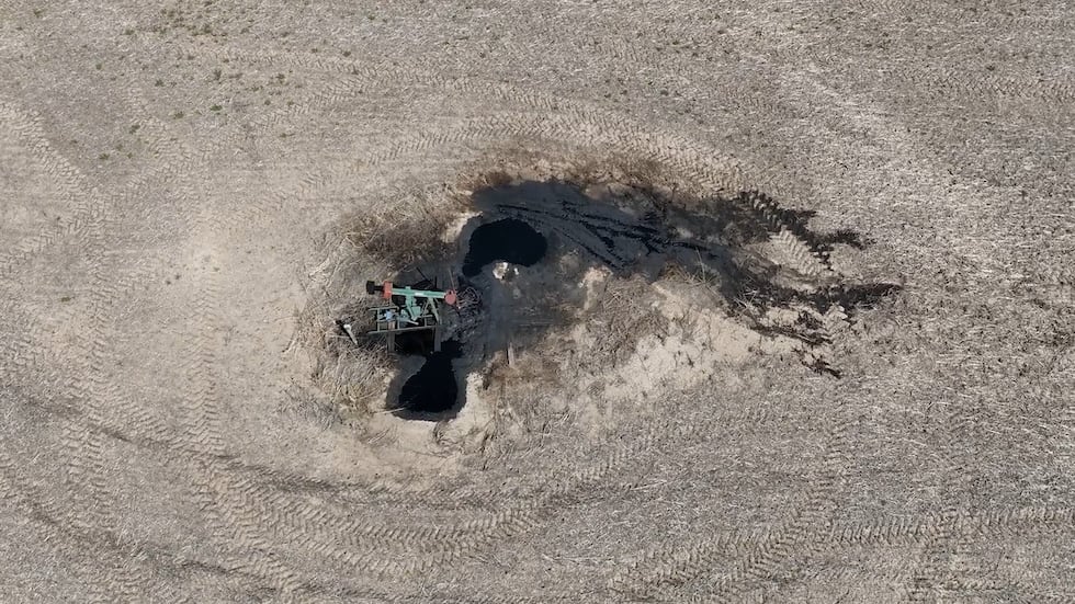 An oil pump leaks on farmland owned by Robert and Clara Kempnich where crops are grown.