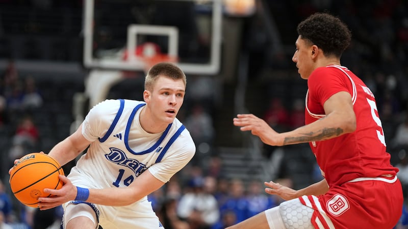 Drake's Bennett Stirtz (14) looks to pass as Bradley's Christian Davis (5) defends during the...