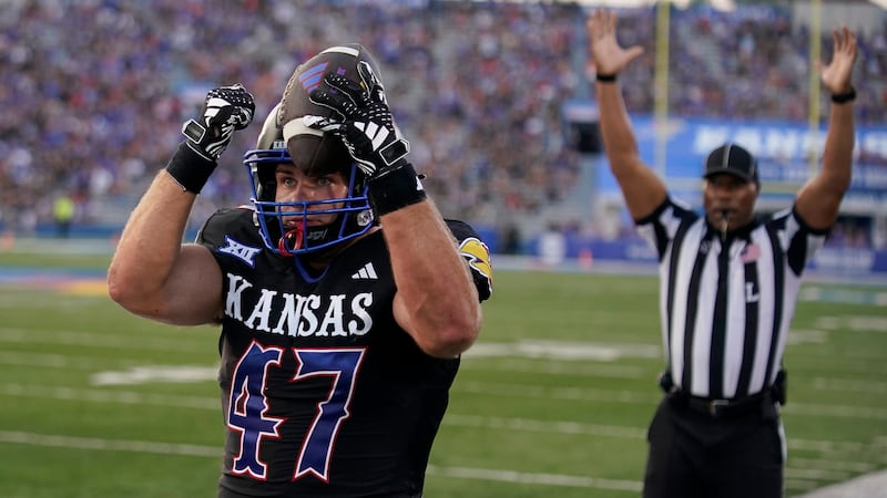 Kansas tight end Jared Casey celebrates after scoring a touchdown during the first half of an...