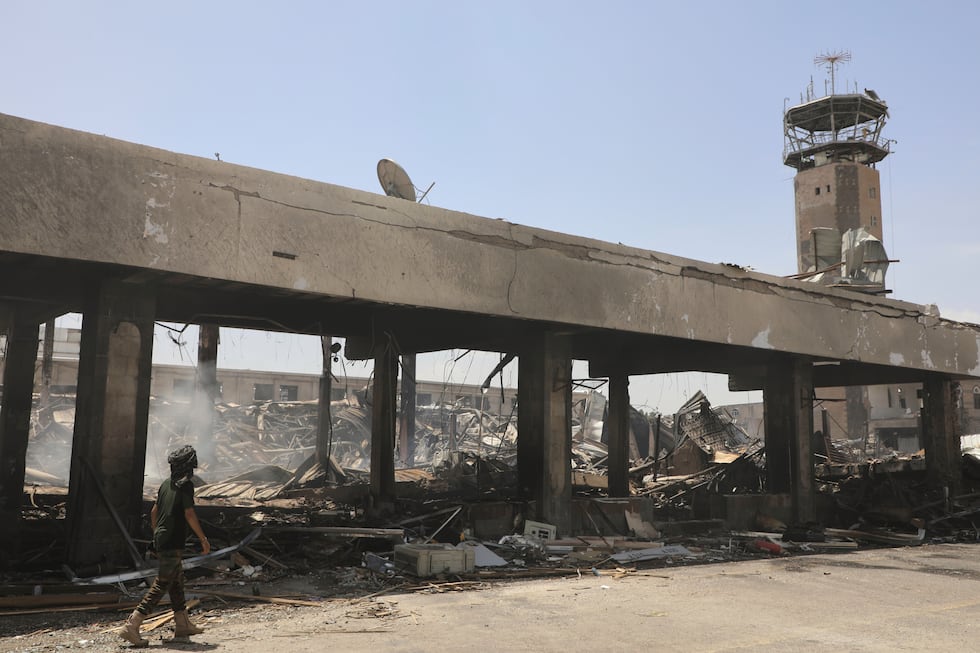 A Yemeni officer inspects the damage following Israeli airstrikes on Sanaa International...
