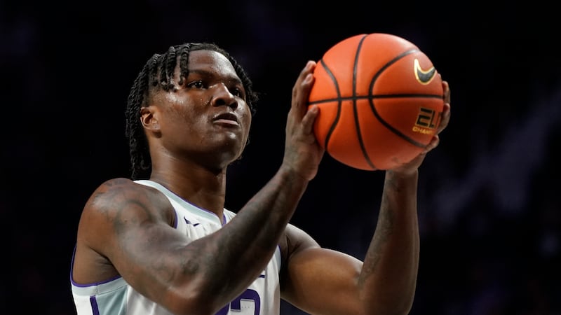 Kansas State forward Macaleab Rich shoots during the first half of an NCAA college basketball...