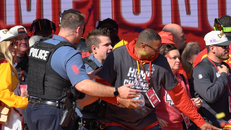 FILE - Police clear the Kansas City Chiefs from the stage after a shooting at their Super Bowl...