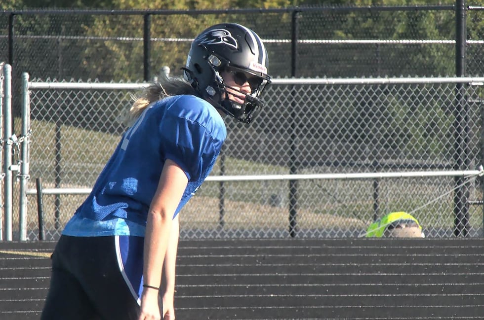 Among the sea of blue and black at Olathe Northwest football practice, you'll find Megan May.