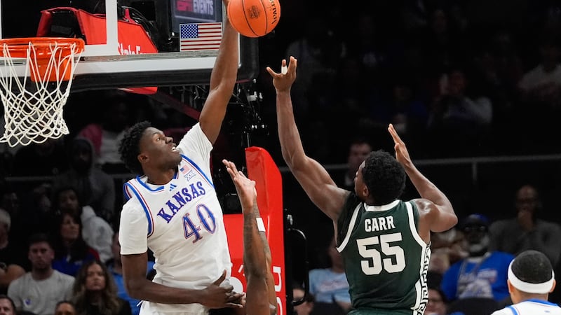 Michigan State forward Coen Carr (55) has his shot blocked by Kansas forward Flory Bidunga...