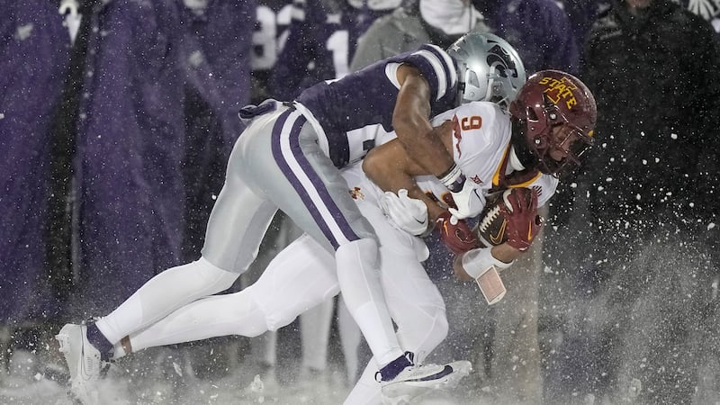 Kansas State safety Marques Sigle, left, tackles Iowa State wide receiver Jayden Higgins (9)...