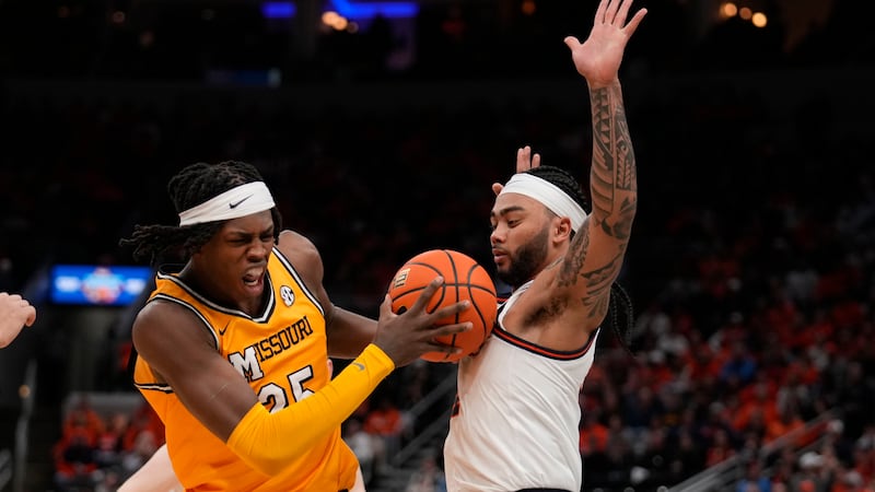 Missouri's Mark Mitchell, left, heads to the basket as Illinois' Kylan Boswell defends during...
