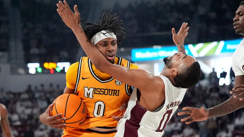 Missouri guard Anthony Robinson II (0) slams into Mississippi State guard Claudell Harris Jr....