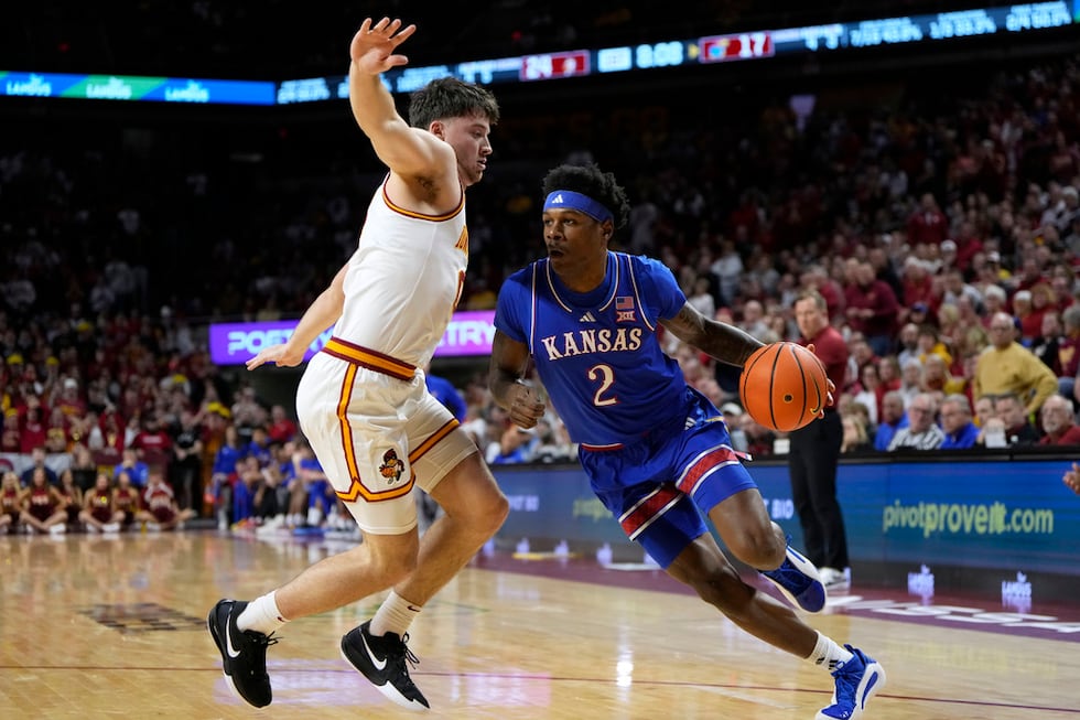 Kansas guard AJ Storr (2) drives past Iowa State guard Nate Heise (0) during the first half of...
