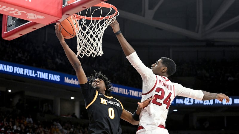 Missouri guard Anthony Robinson II (0) tries to drive past Arkansas forward Billy Richmond III...