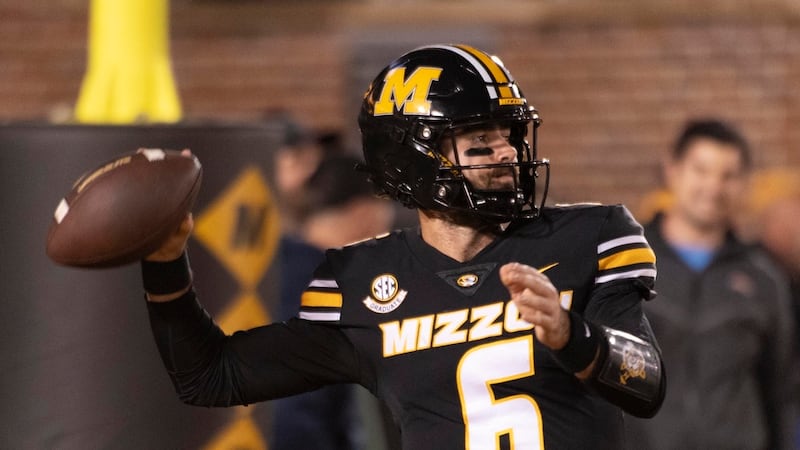 Missouri quarterback Drew Pyne warms up before an NCAA college football game against Oklahoma...