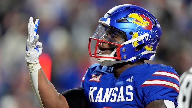 Kansas running back Devin Neal celebrates after making a touchdown during the second half of...