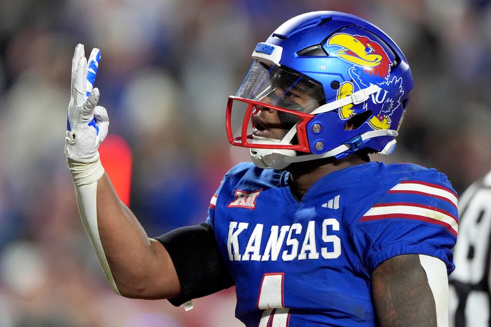 Kansas running back Devin Neal celebrates after making a touchdown during the second half of...