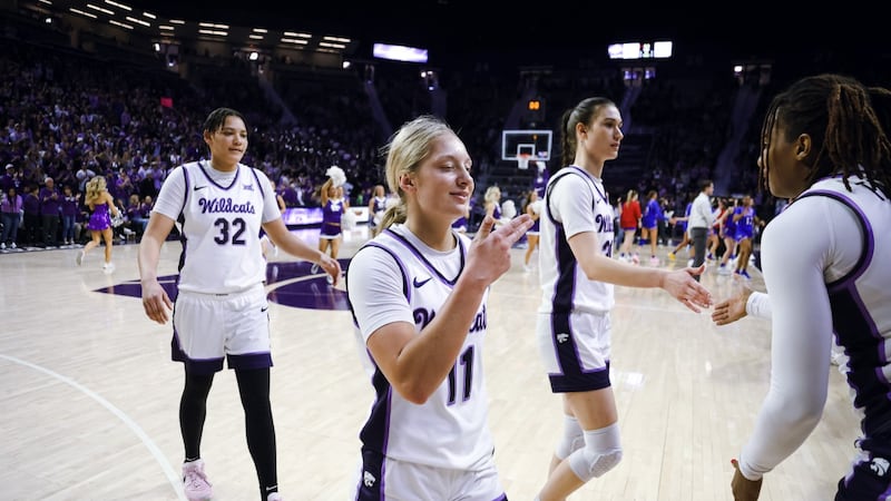 Taryn Sides walks back to the K-State bench
