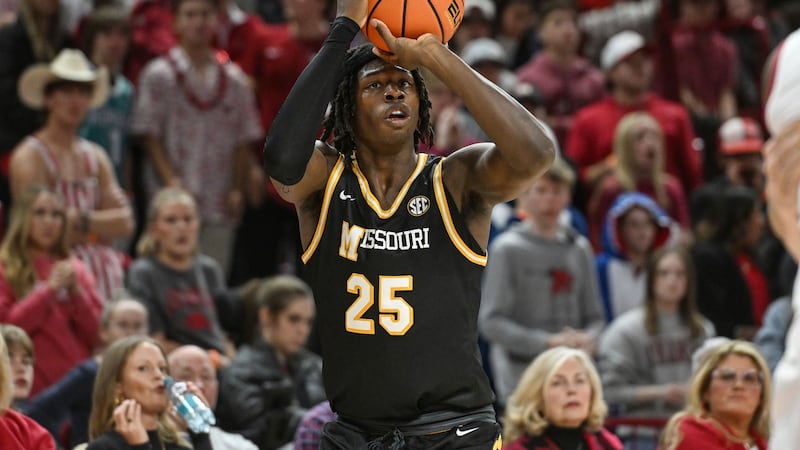 Missouri guard Mark Mitchell (25) shoots a three point shot against Arkansas during the first...