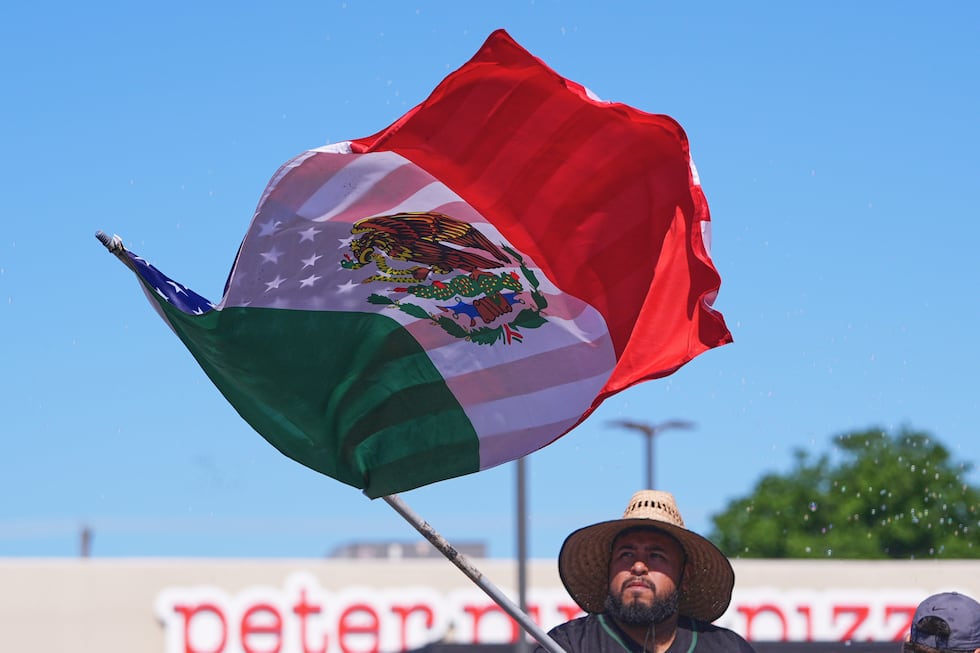 A float rider waves a U.S.-Mexico flag during a Cinco de Mayo parade in the Oak Cliff section...