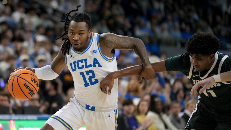 UCLA guard Sebastian Mack (12) dribbles against Michigan State guard Jase Richardson (11)...