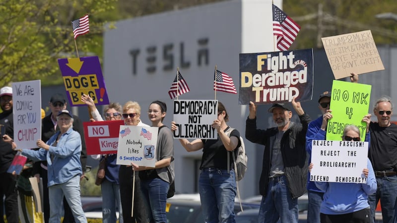 Demonstrators protest against Elon Musk and Department of Government Efficiency cuts outside a...