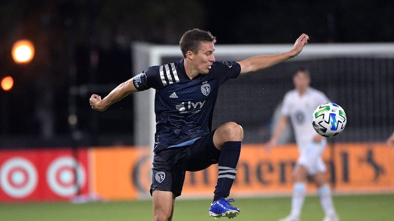 Sporting Kansas City defender Matt Besler, left, controls a pass during the first half of an...