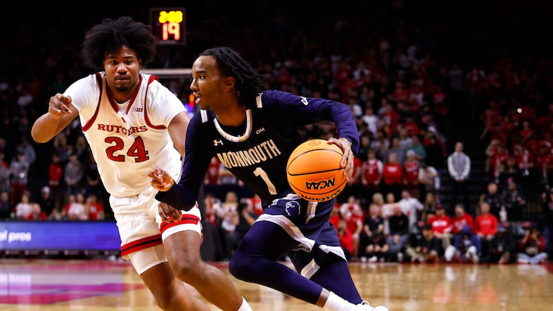 Monmouth guard Abdi Bashir Jr. (1) drives to the basket against Rutgers center Lathan...