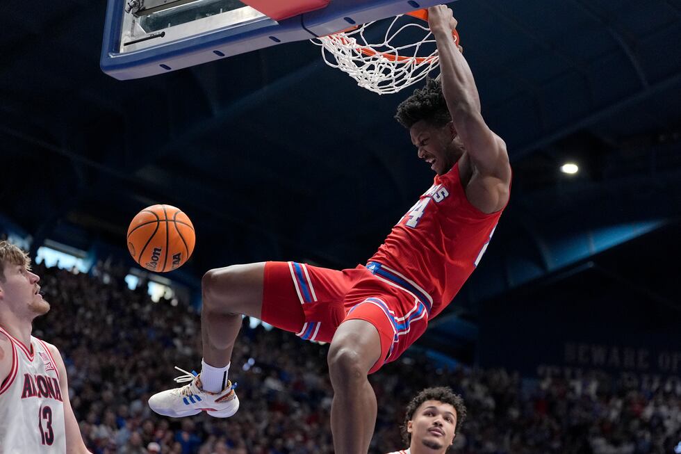 Kansas forward KJ Adams Jr. (24) dunks the ball during the first half of an NCAA college...