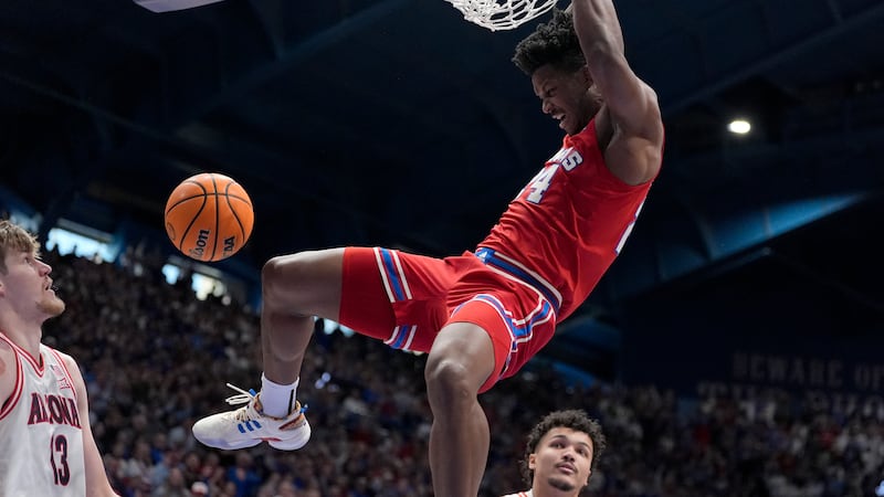 Kansas forward KJ Adams Jr. (24) dunks the ball during the first half of an NCAA college...