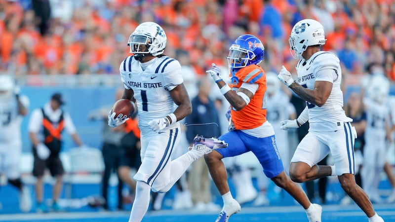 Utah State wide receiver Jalen Royals (1) runs past the Boise State defense on a 75-yard...