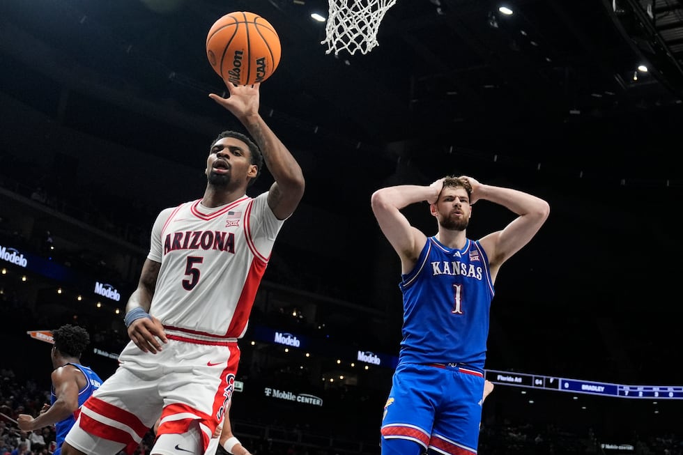 Kansas' Hunter Dickinson (1) reacts after fouling Arizona's KJ Lewis (5) during the second...