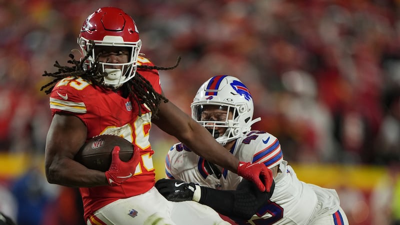 Kansas City Chiefs running back Kareem Hunt, left, gains against Buffalo Bills linebacker...