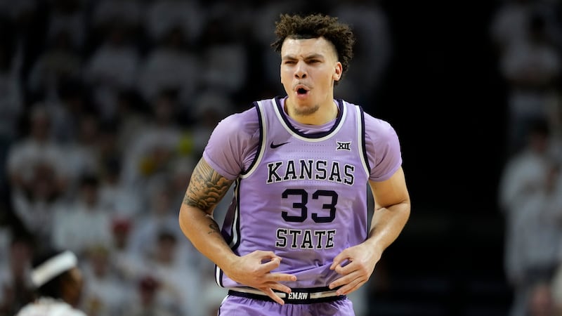 Kansas State guard Coleman Hawkins celebrates after making a three-point basket during the...