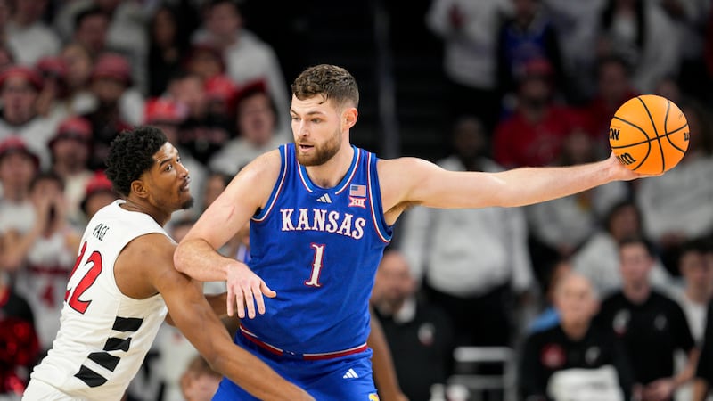 Kansas center Hunter Dickinson (1) is guarded by Cincinnati forward Arrinten Page (22) during...