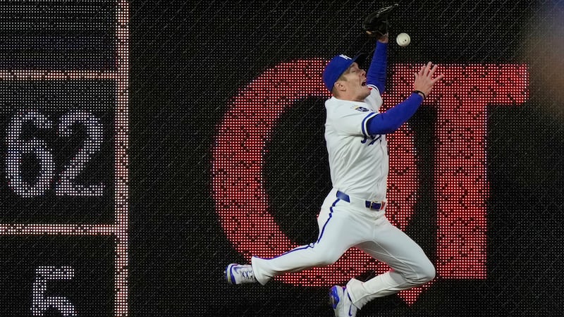 Kansas City Royals left fielder Mark Canha can't catch a double hit by Minnesota Twins'...