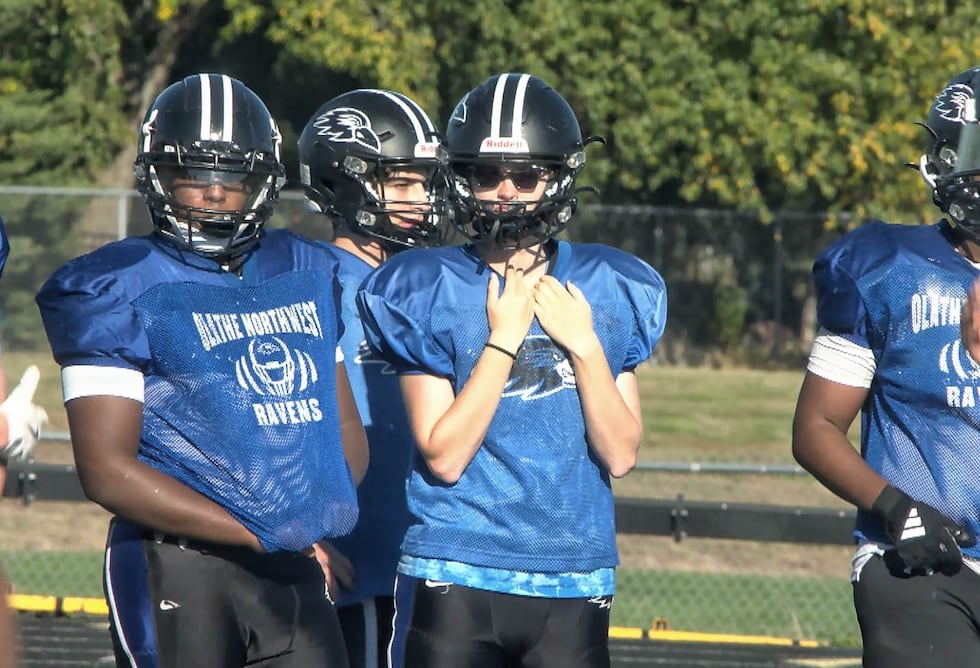 Among the sea of blue and black at Olathe Northwest football practice, you'll find Megan May.