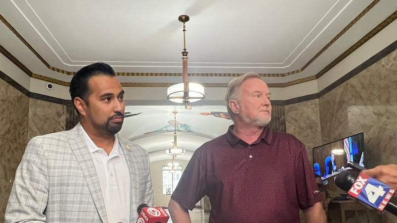 Jacksoun County legislators Manny Abarca (left) and Sean Smith address their concerns over the...