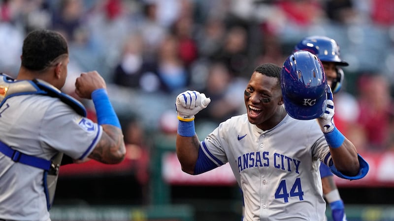 Kansas City Royals' Dairon Blanco, right, is congratulated by Salvador Perez after hitting a...