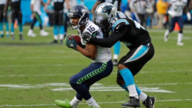 Seattle Seahawks' Tyler Lockett (16) catches a pass against Carolina Panthers' Captain...